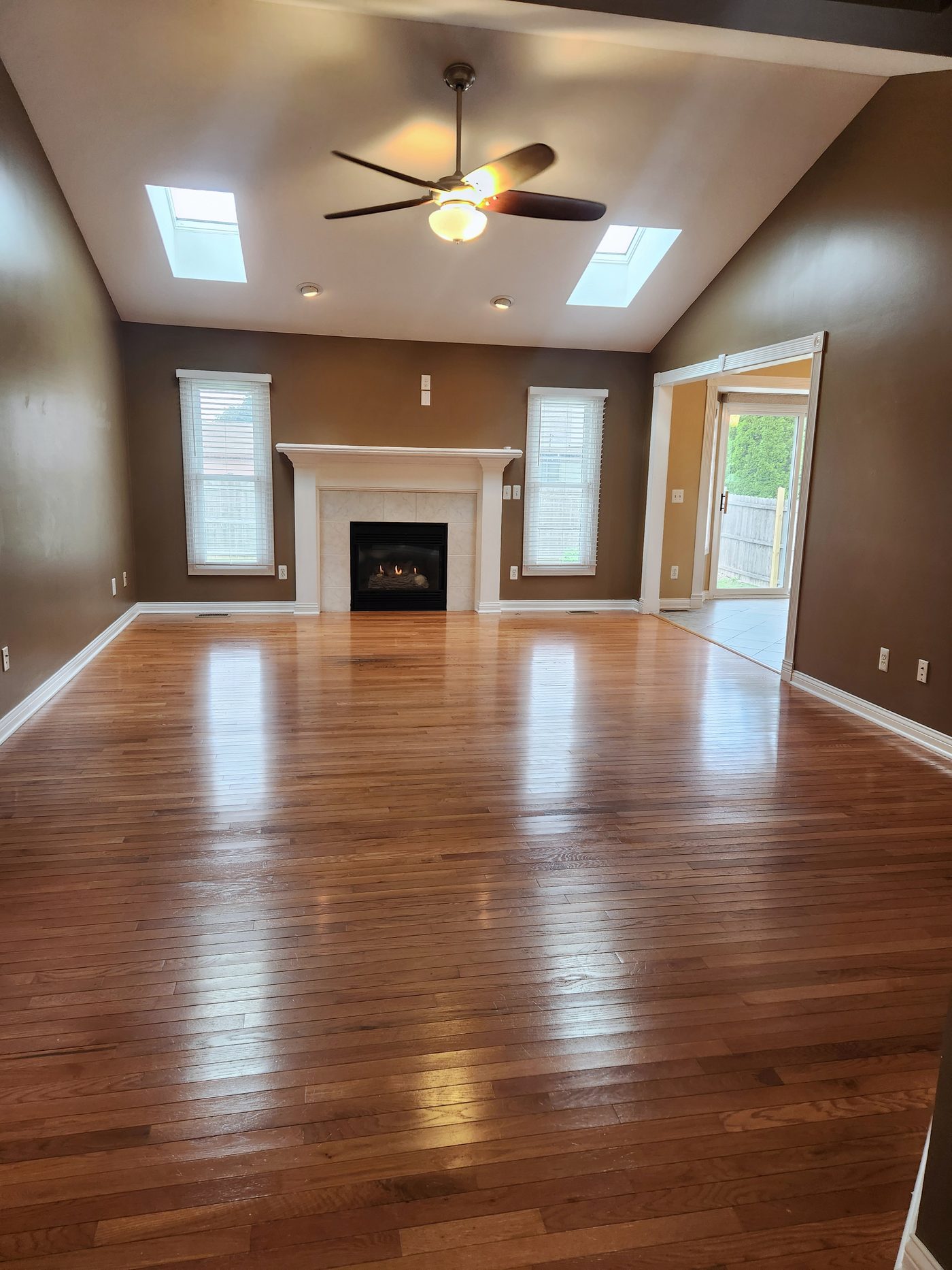 Vaulted great room with gas fireplace and twin skylights