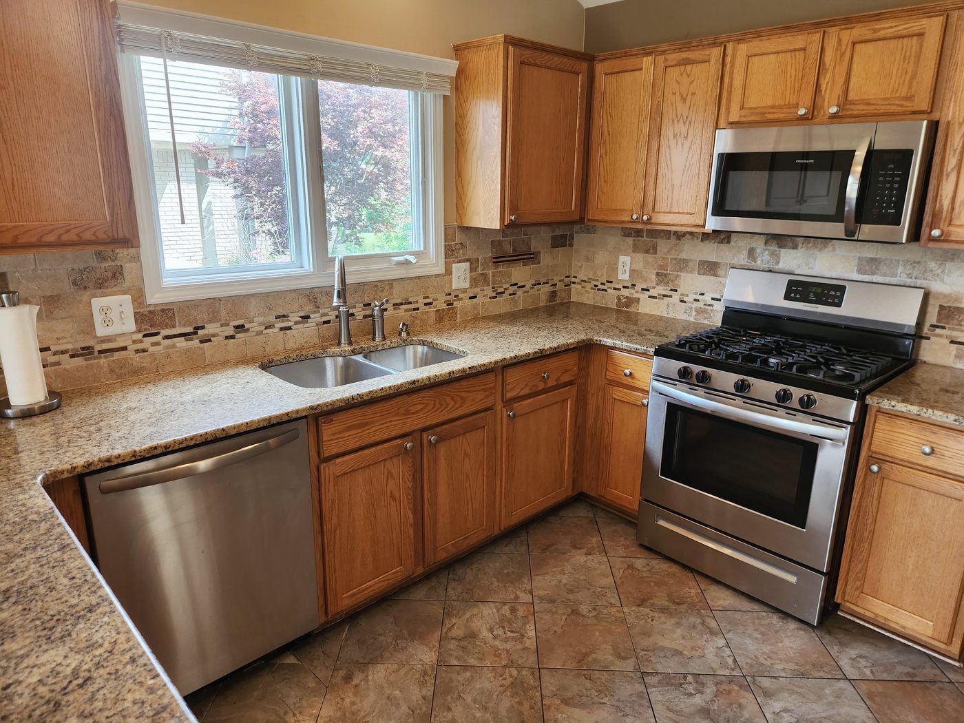 Granite kitchen with stainless appliances and gas range
